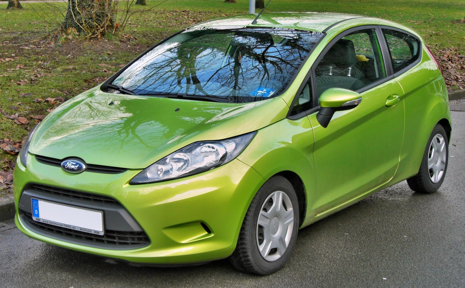 Front view of a compact 3-door hatchback with distinctive headlights and grille.