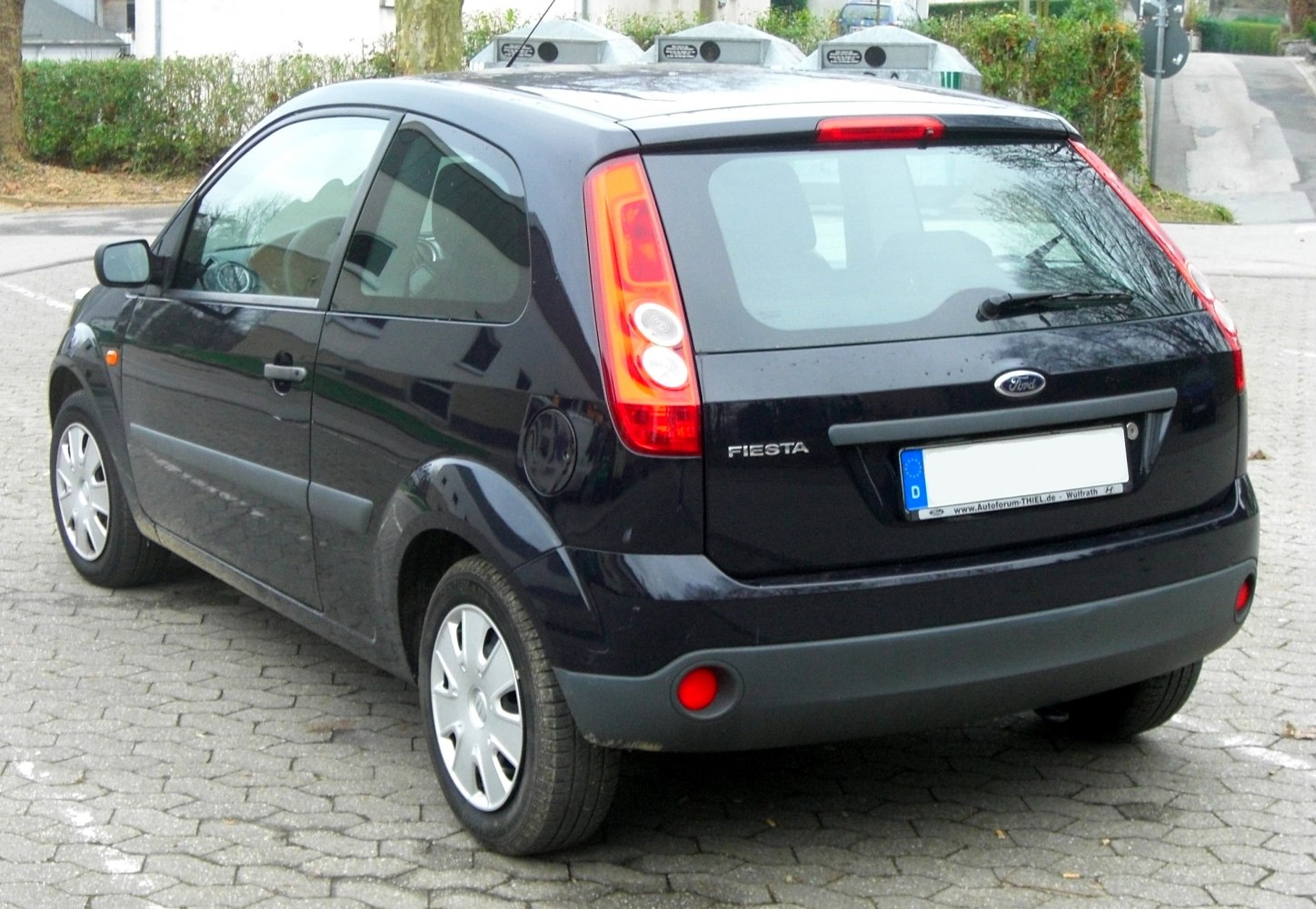 Rear view of 3-door hatchback with vertical tail lights and tinted glass