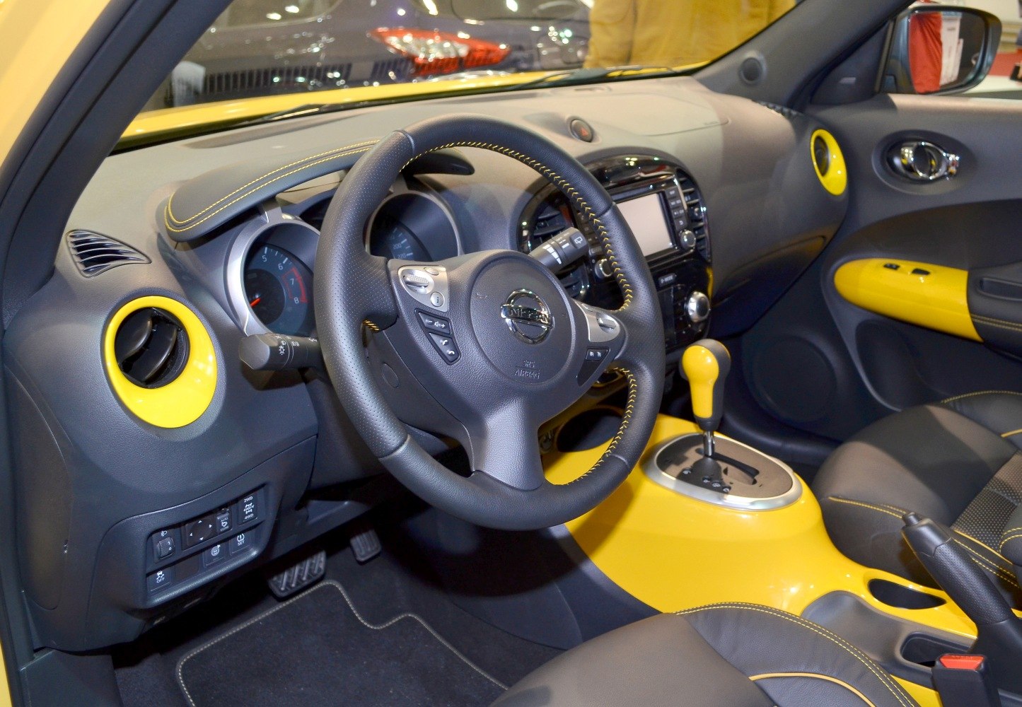 Interior with yellow accents on dashboard, vents, steering wheel, and gear shift