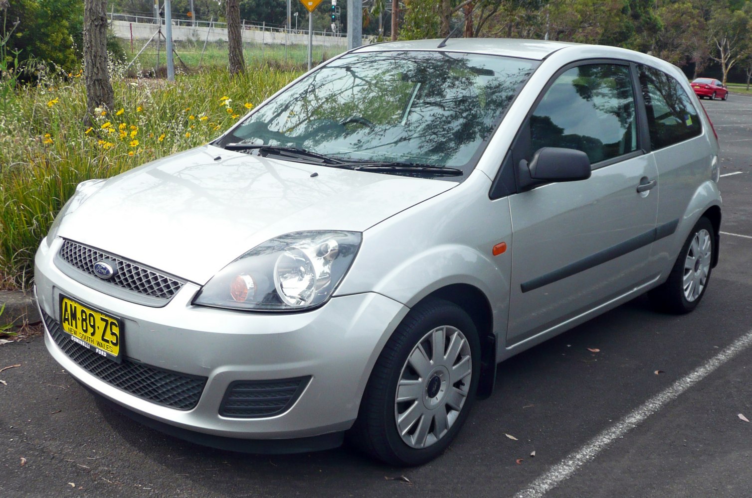 Silver 3-door hatchback with prominent headlights and front grille