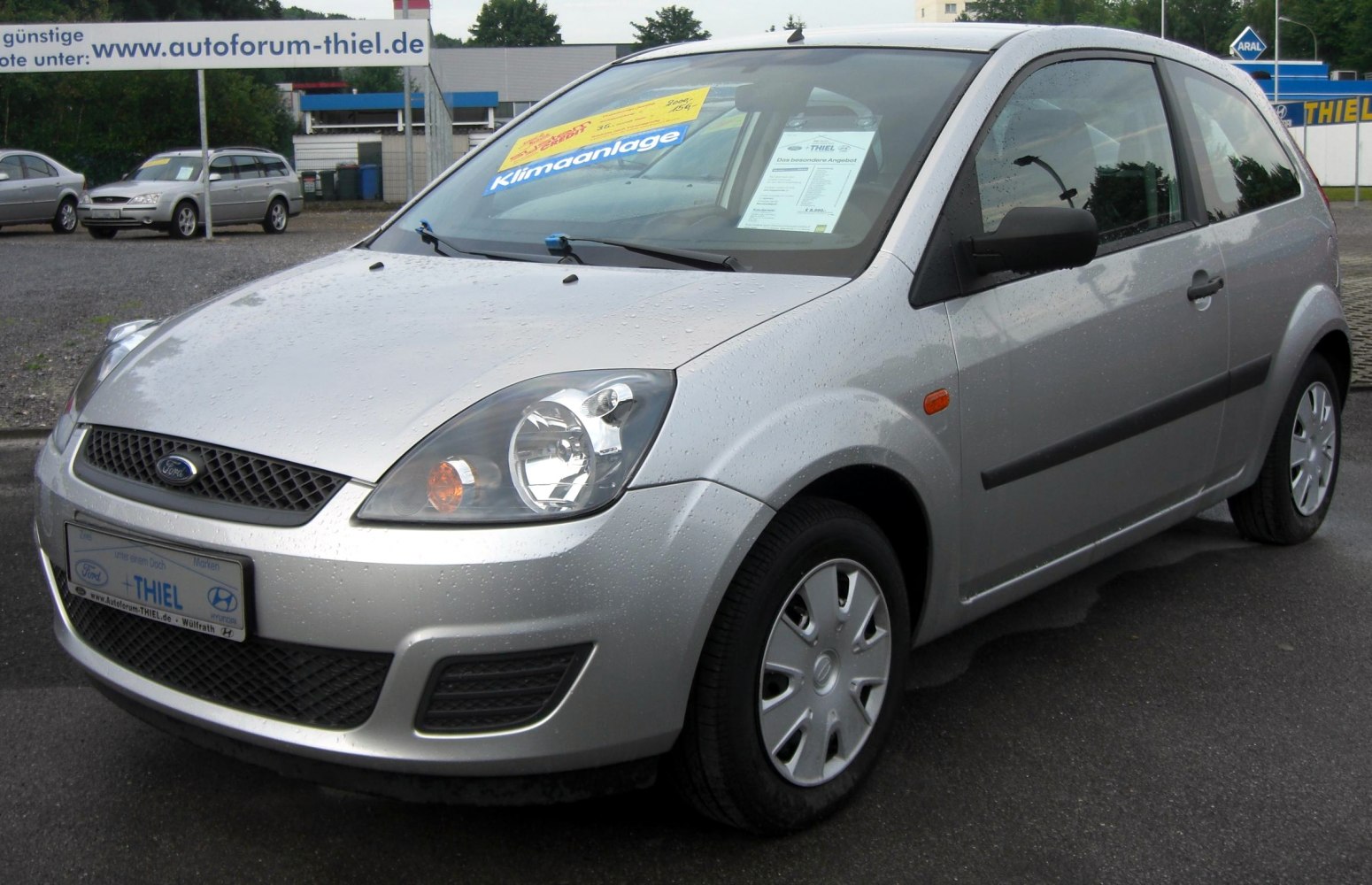 Silver 3-door hatchback with clear headlights and black side trim