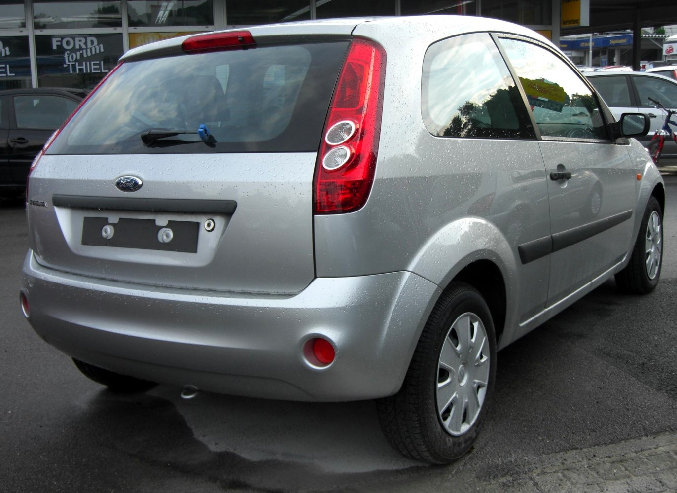Silver 3-door hatchback rear view with vertical tail lights and black trim