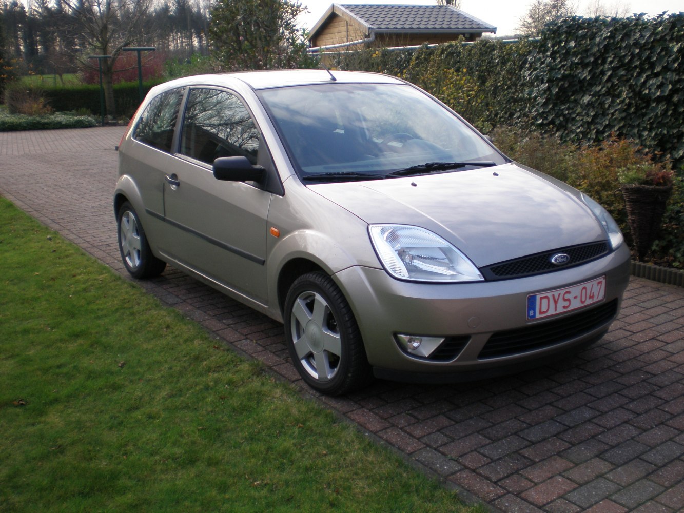 3-door compact hatchback with sleek headlights and alloy wheels