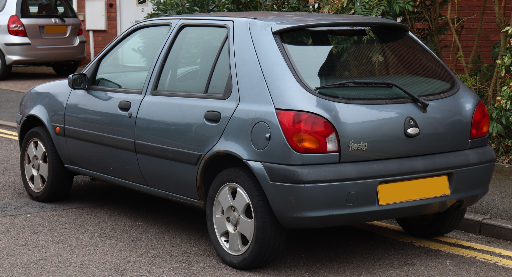 Rear and side view of 5-door hatchback with taillights, alloy wheels, and rear wiper