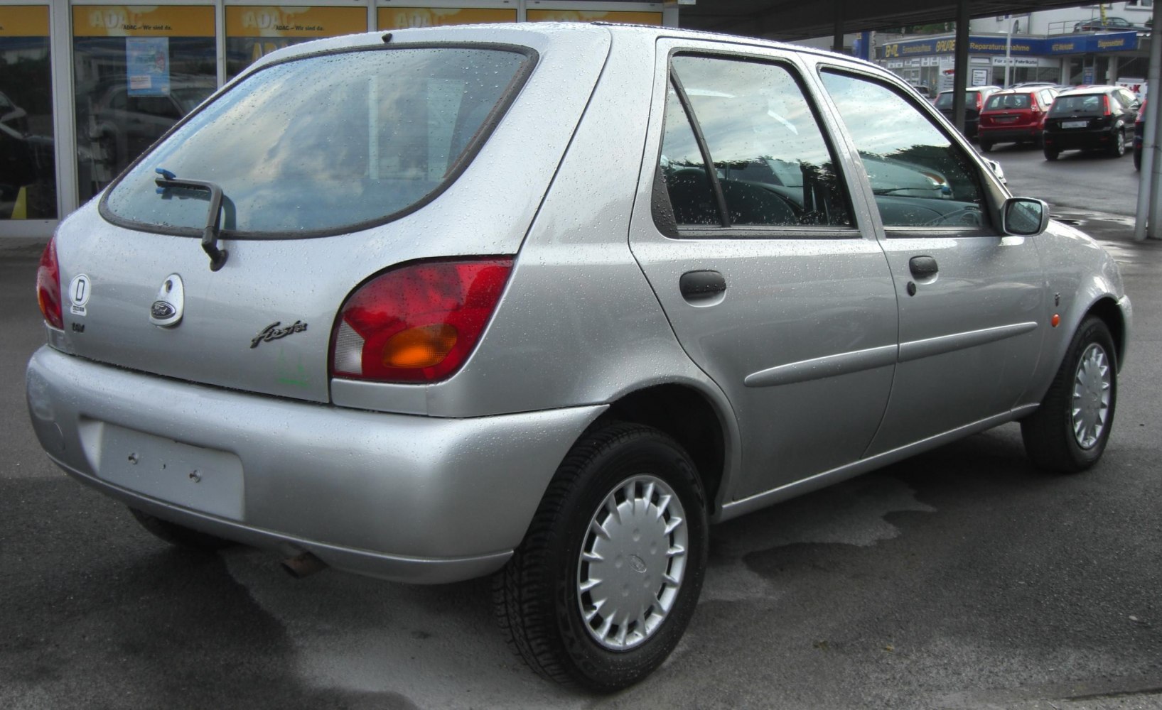 Rear view of silver 5-door hatchback with unique taillights and hubcaps.