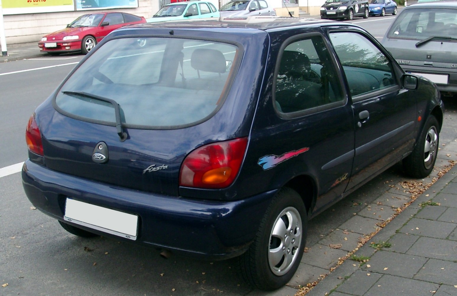 Rear and side view of compact 3-door hatchback with distinctive taillights.