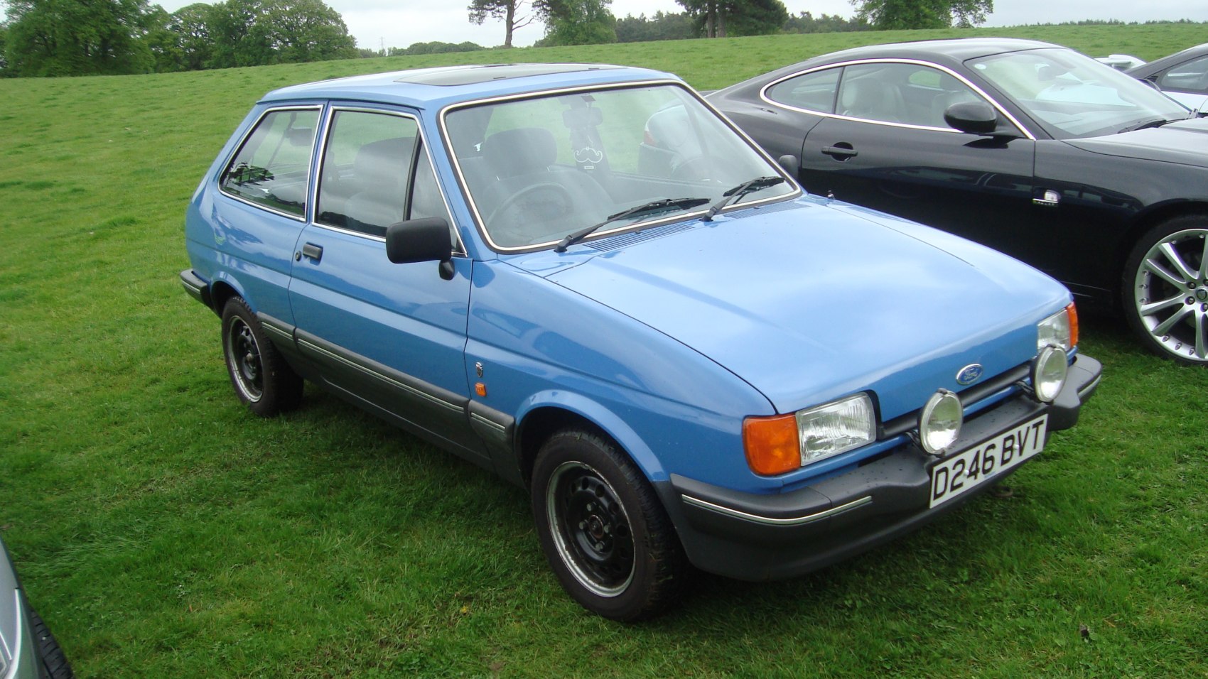 1980s compact hatchback with front spotlights and angular design