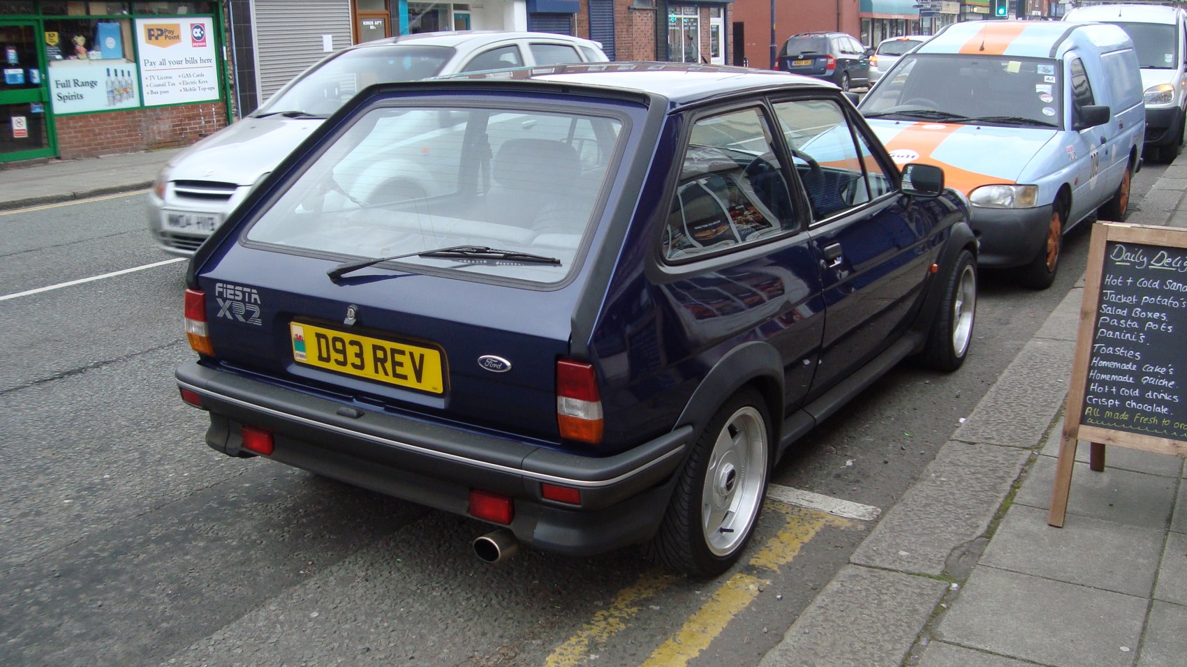 Rear hatchback view with wide alloy wheels and sporty trims