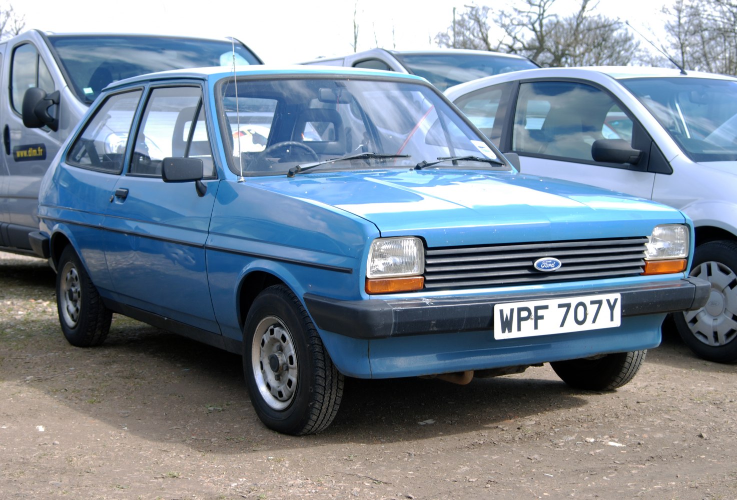 Blue vintage hatchback with rectangular headlights and steel wheels