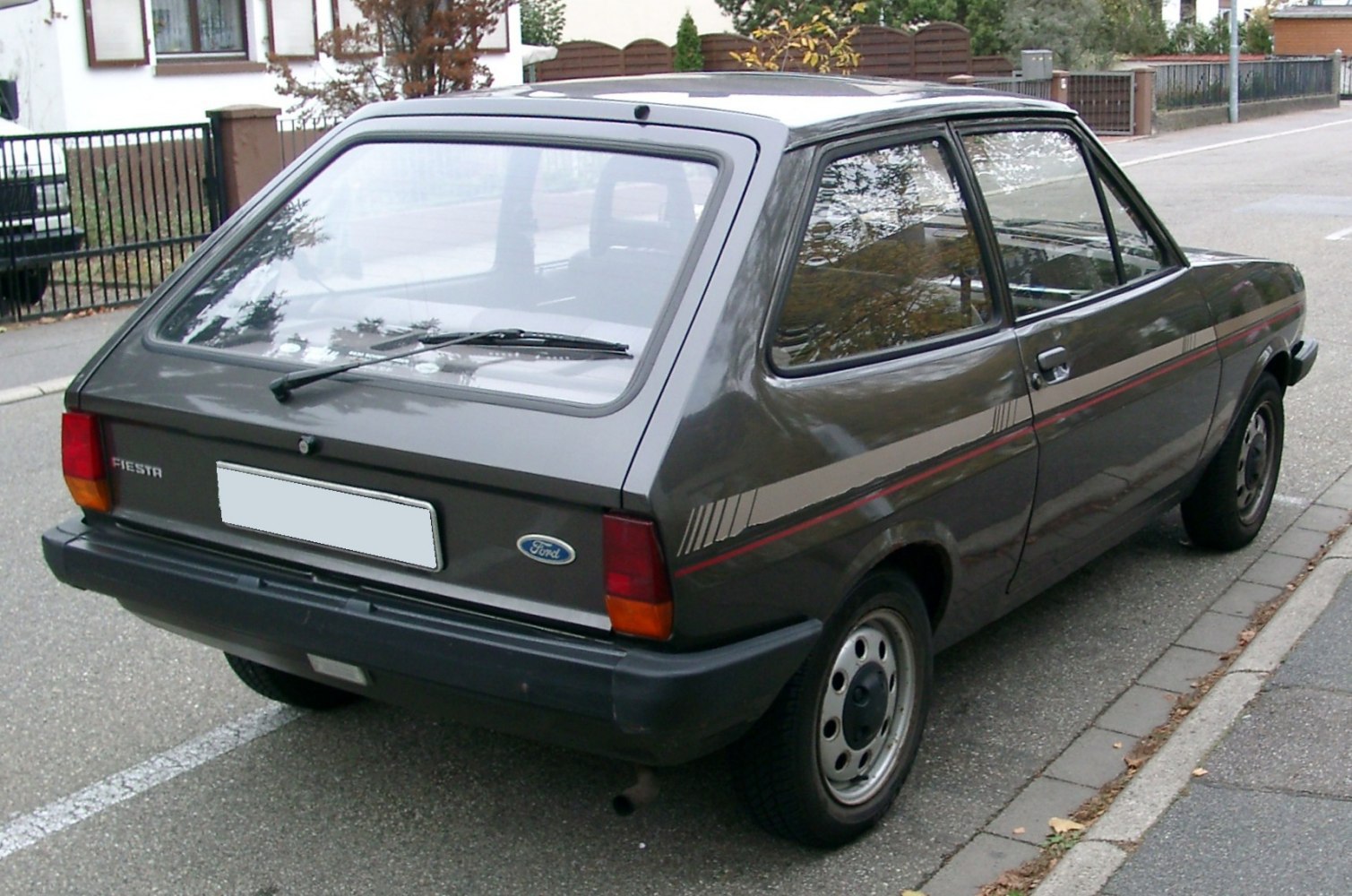 Rear view of classic hatchback with rear windshield wiper and side stripes