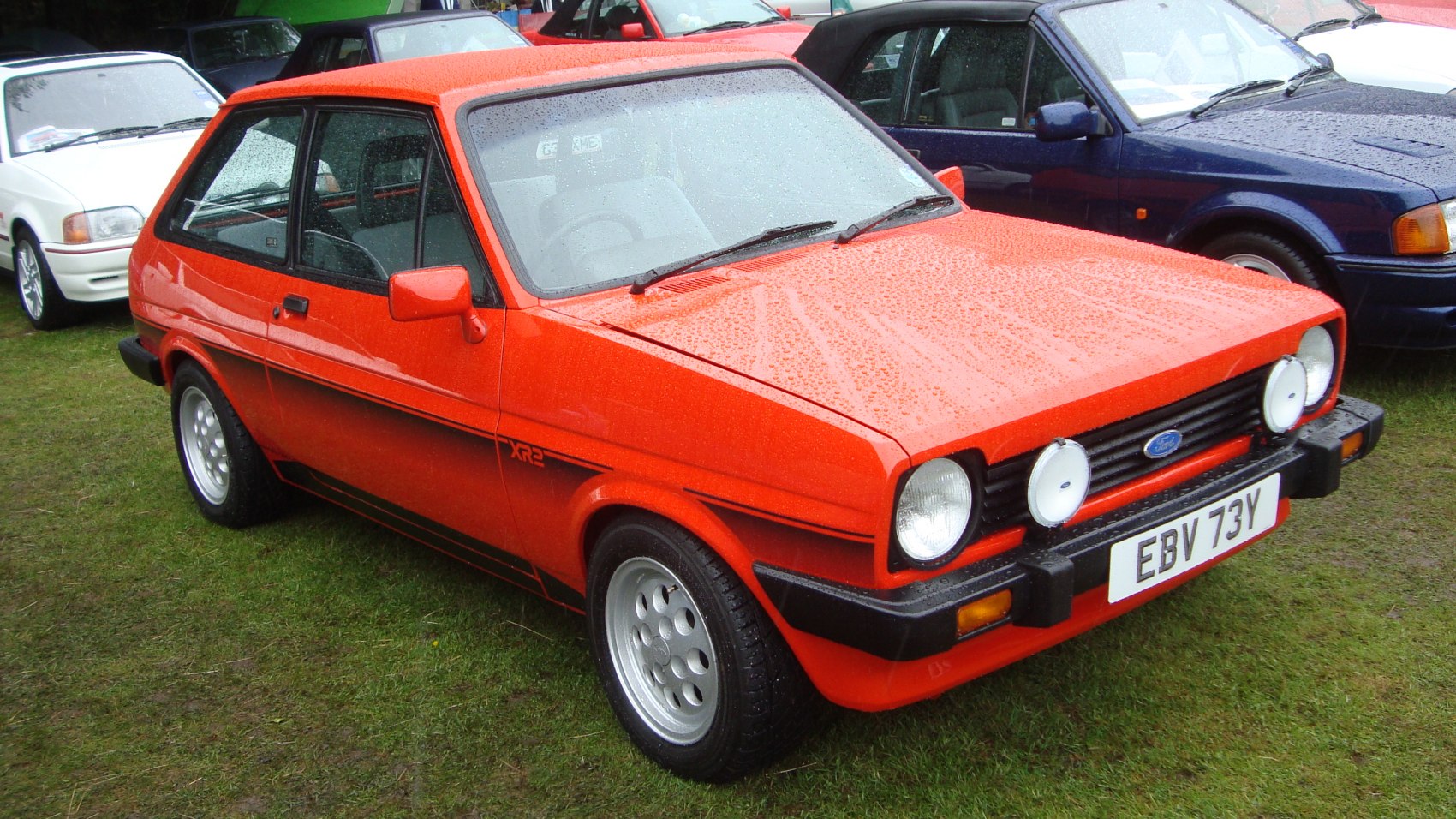 Classic 1970s hatchback with round headlights and rally lights