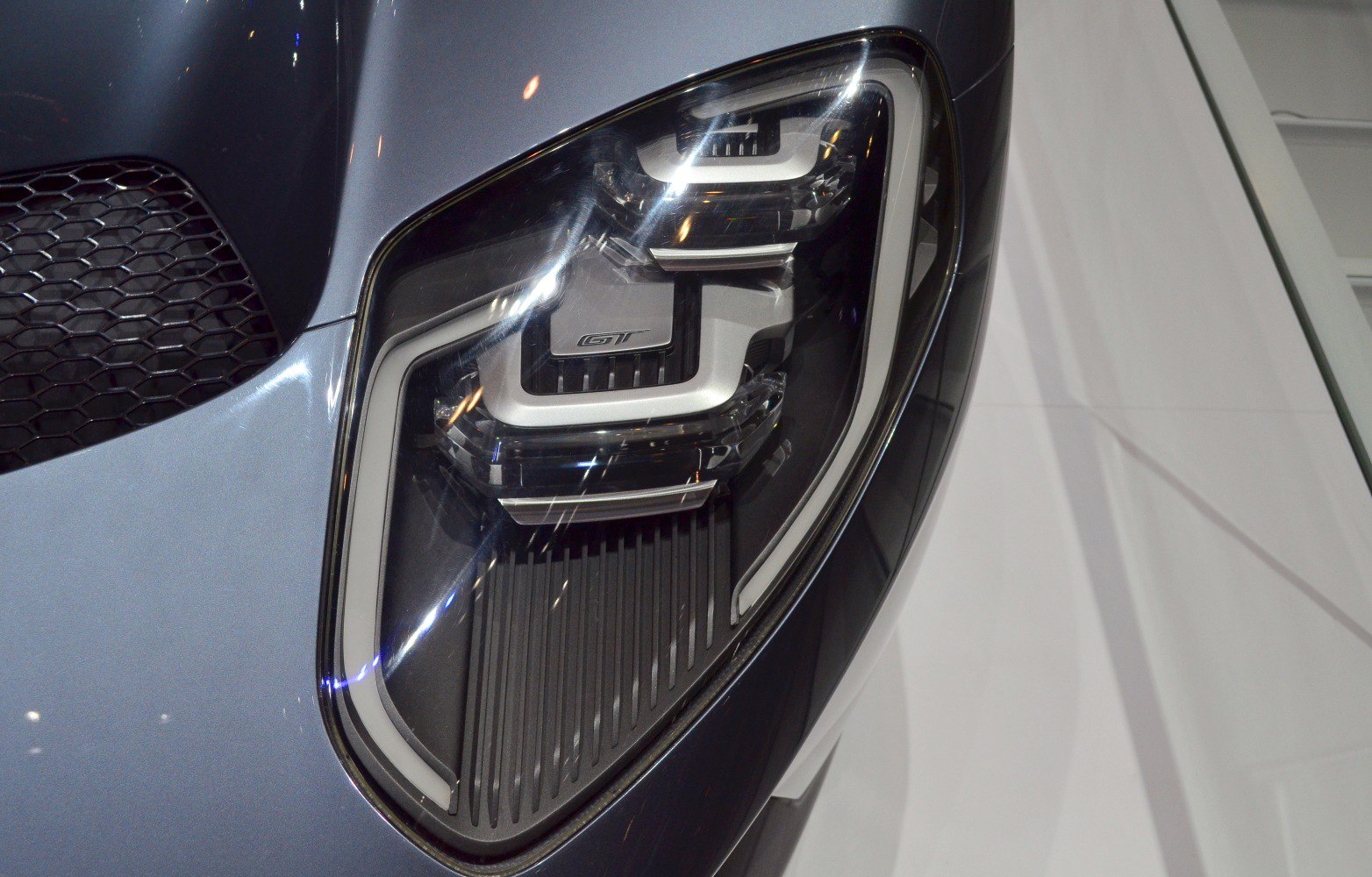 Close-up of a modern LED headlight with distinctive design and GT badge