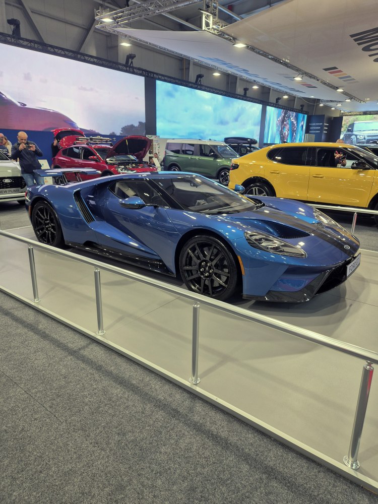 Sleek aerodynamic sports car with sharp curves and black wheels