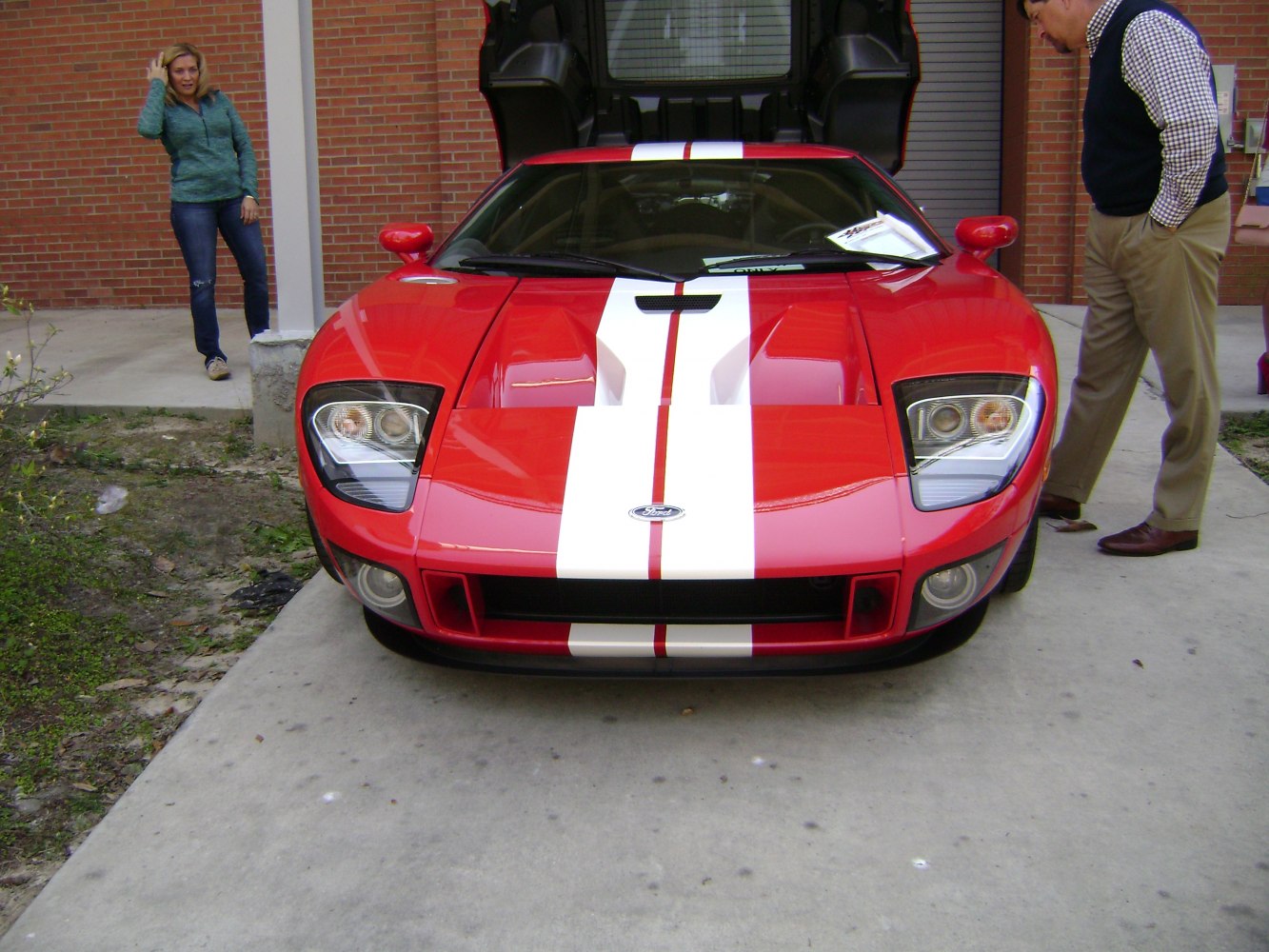 Front view of a sports car with racing stripes and aerodynamic features.