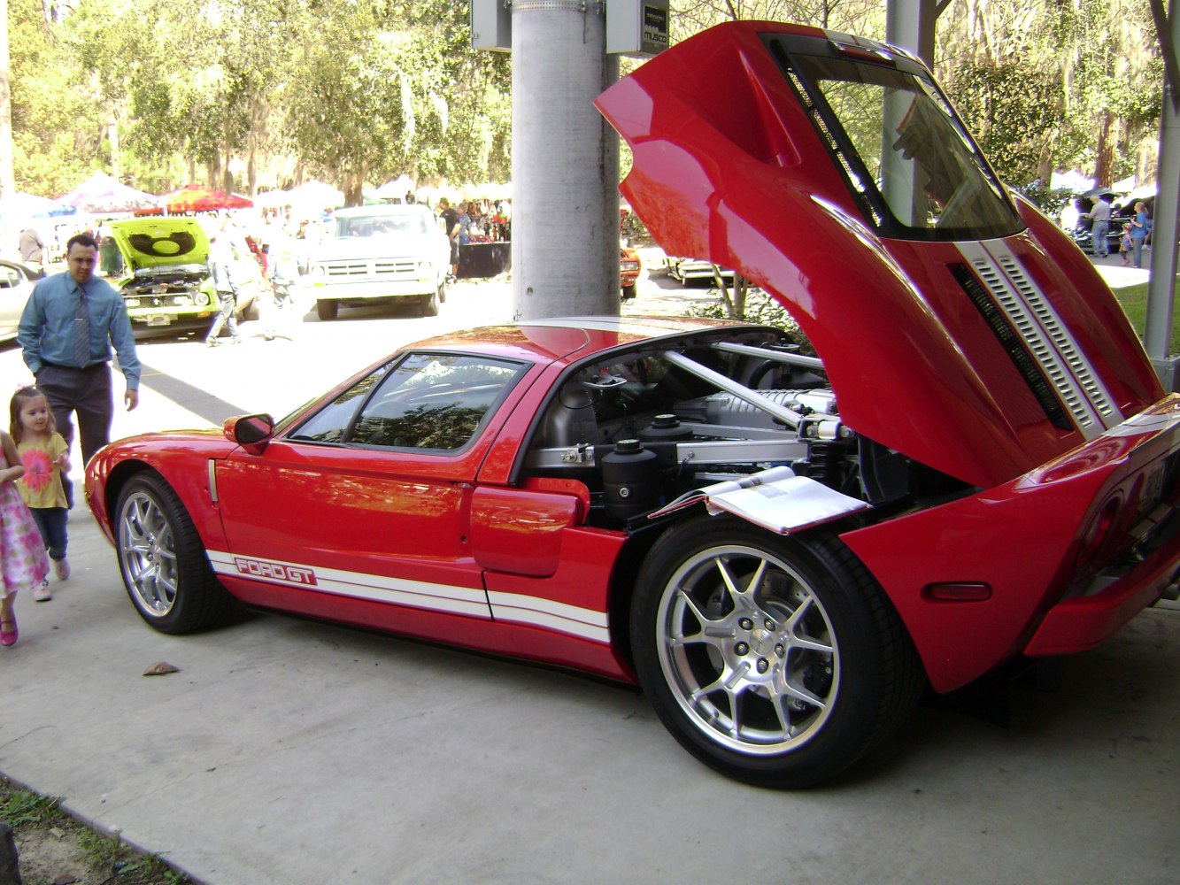 Rear engine bay with open hood and alloy wheels