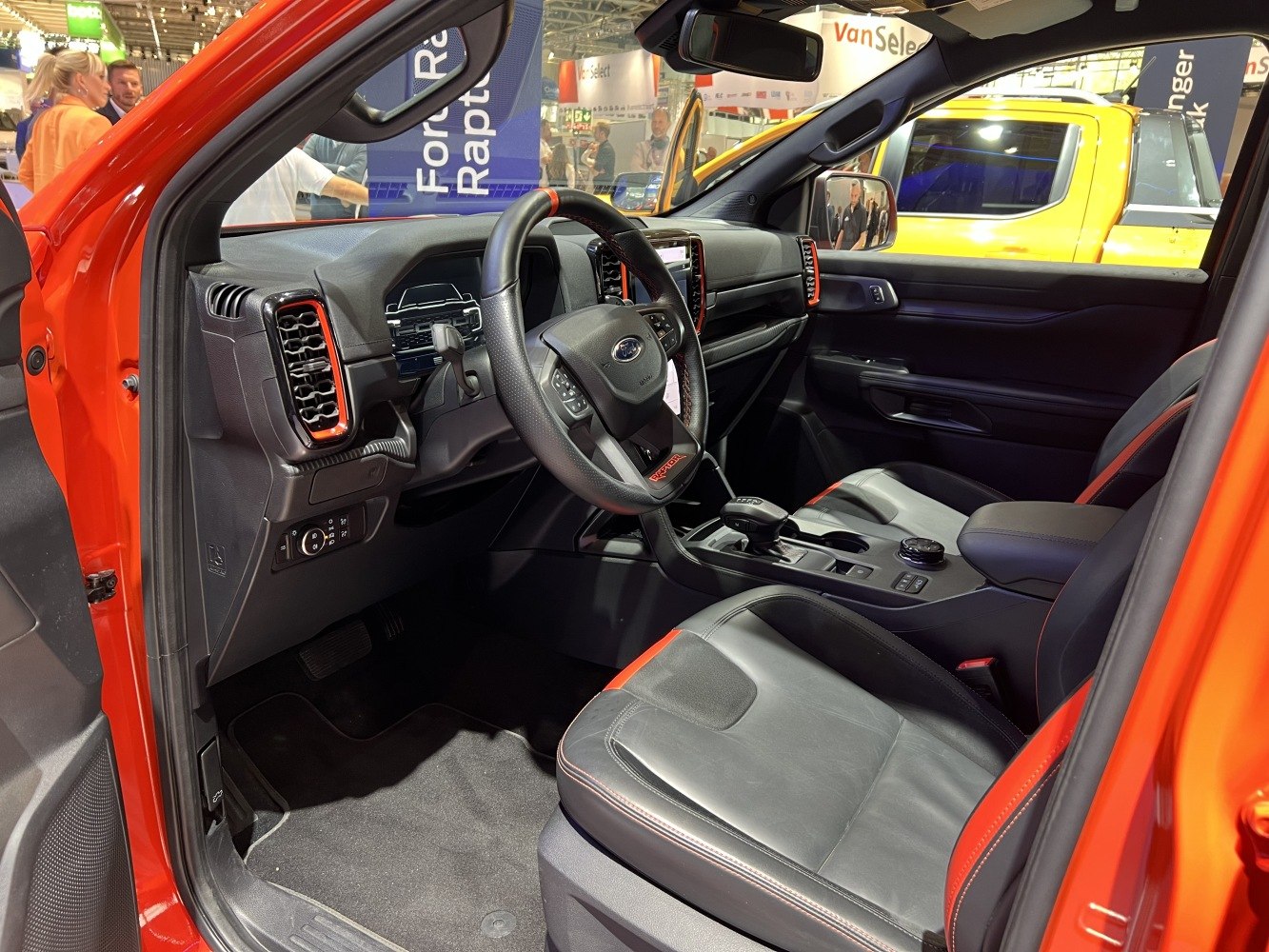 Modern dashboard and black leather seats with red accents
