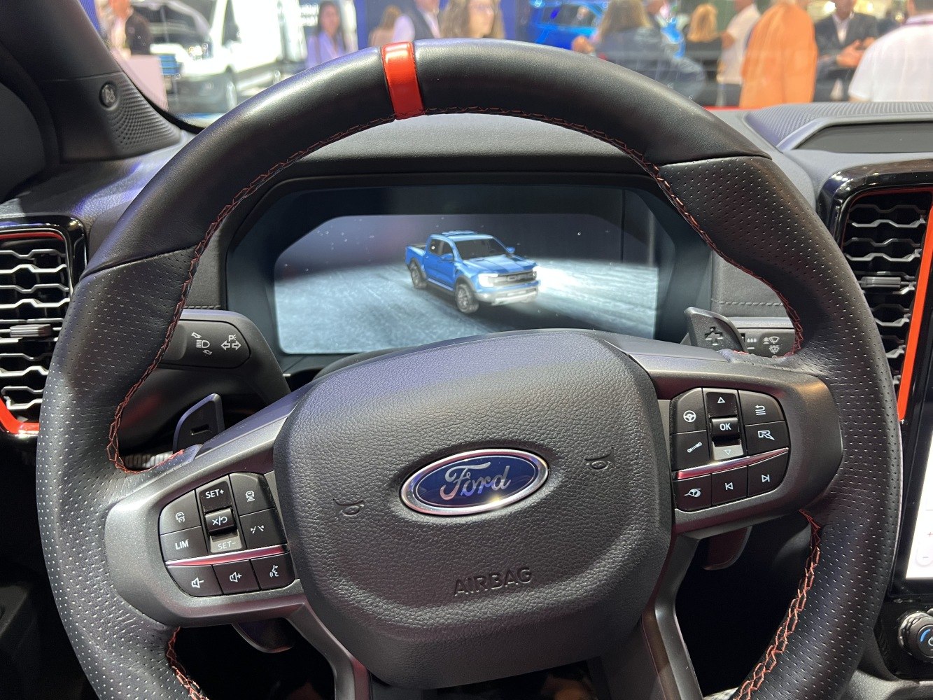 Steering wheel with control buttons and digital instrument cluster display
