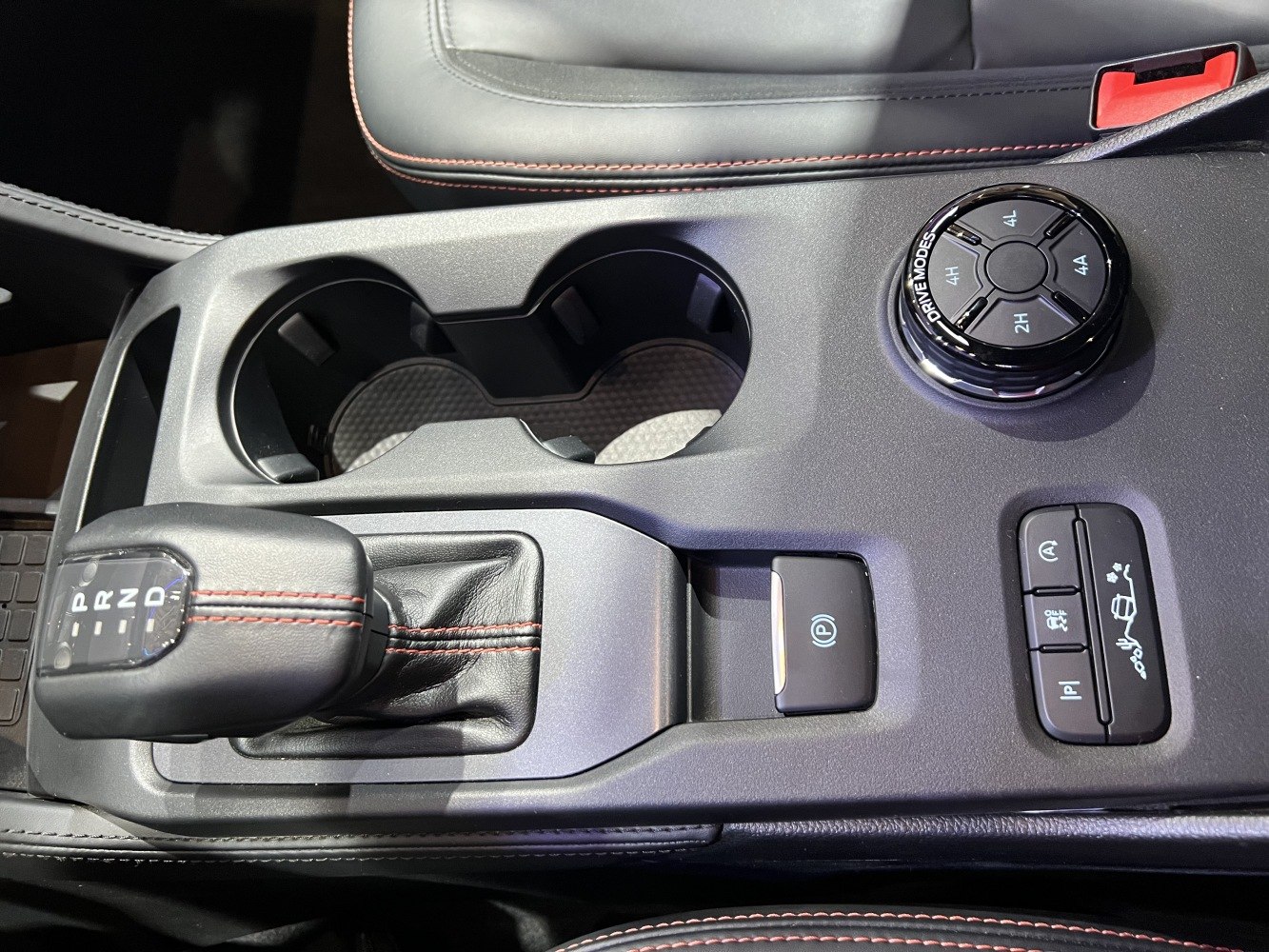 Gear shift lever, drive mode selector, electronic parking brake, cup holders