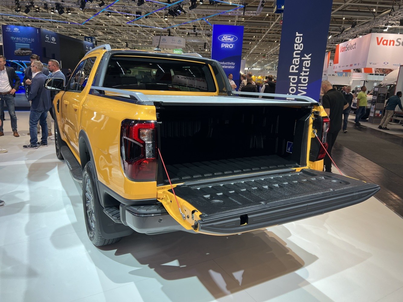 Open pickup truck cargo bed with lowered tailgate and protective liner