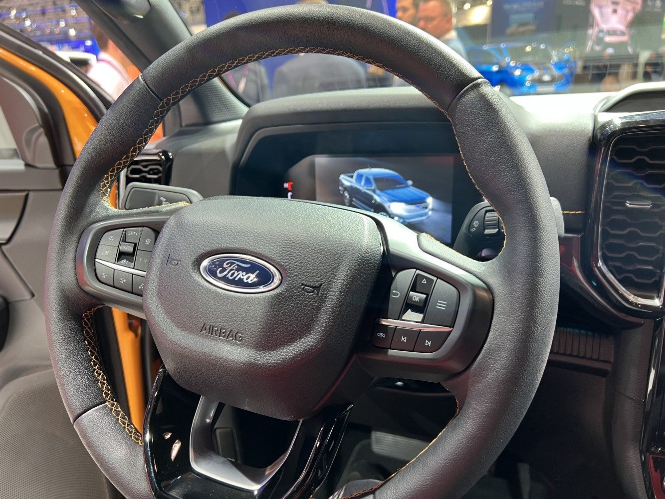 Leather steering wheel and digital dashboard display with pickup truck image