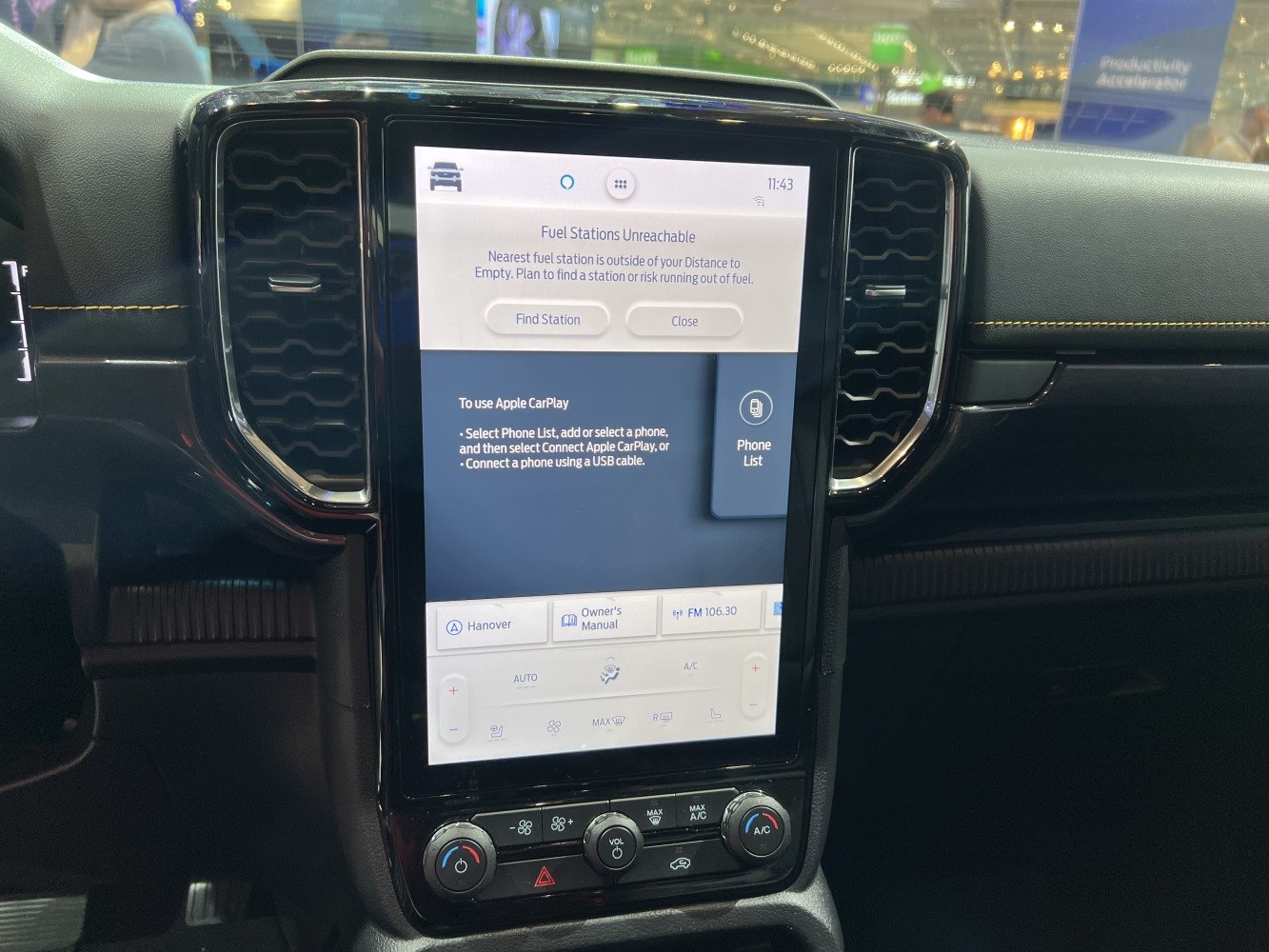 Touchscreen infotainment system and manual climate controls with knobs