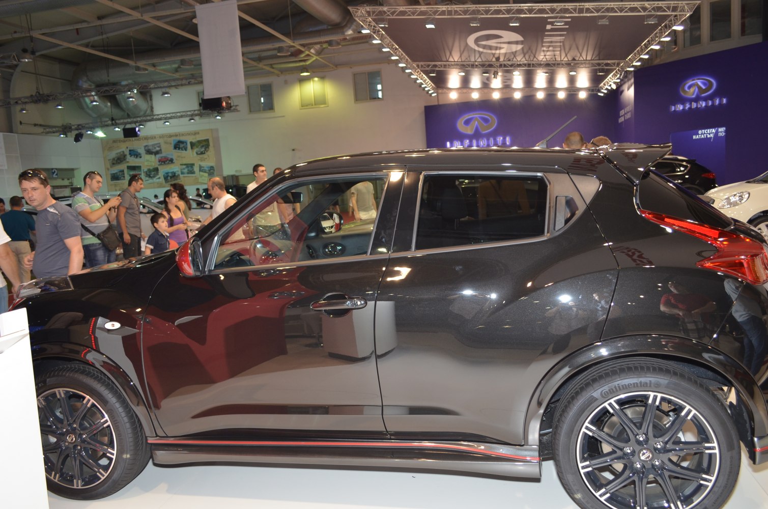 Sleek side profile with black alloy wheels and rear spoiler