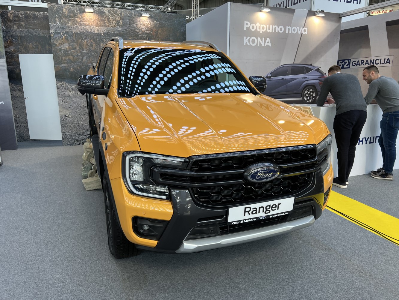 Front view of pickup with bold black grille and headlight design