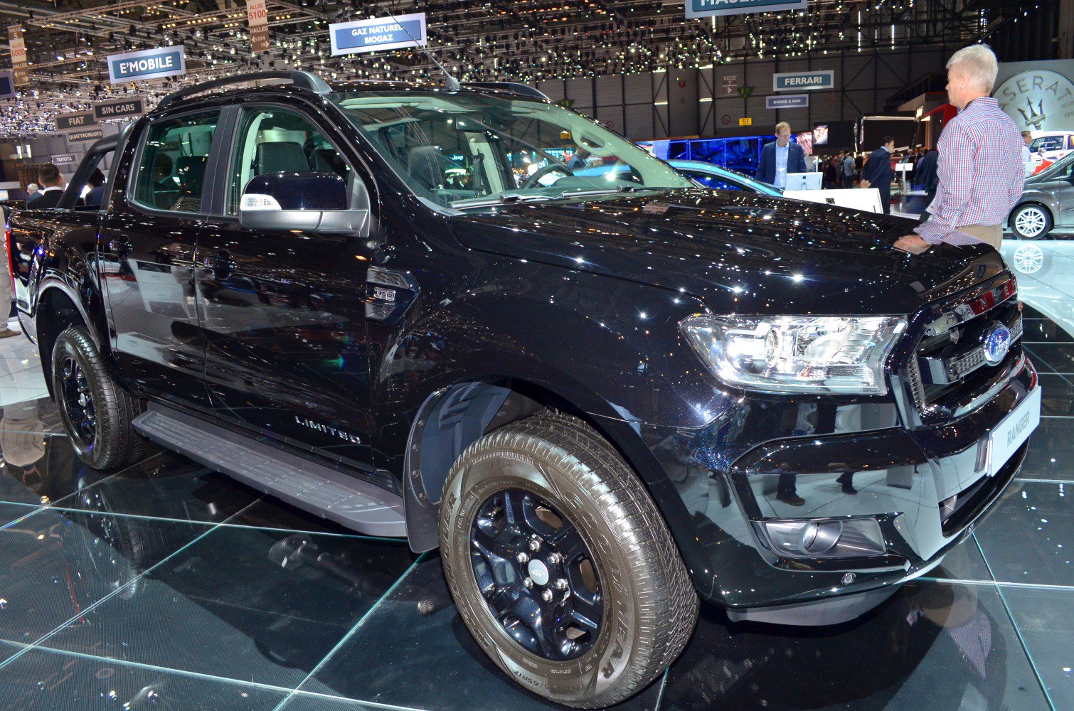 Black double cab pickup with sporty wheels and running boards