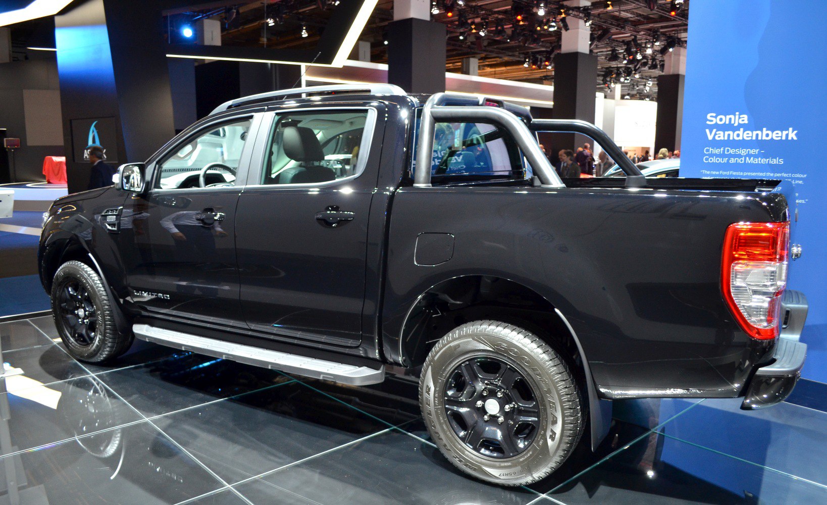 Double cab pickup with black wheels and roll bars