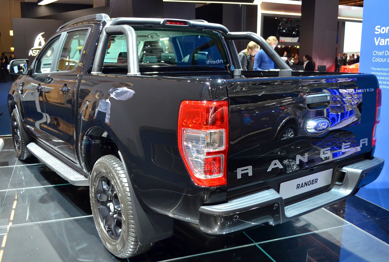 Black double cab pickup rear view with chrome sports bar and tailgate