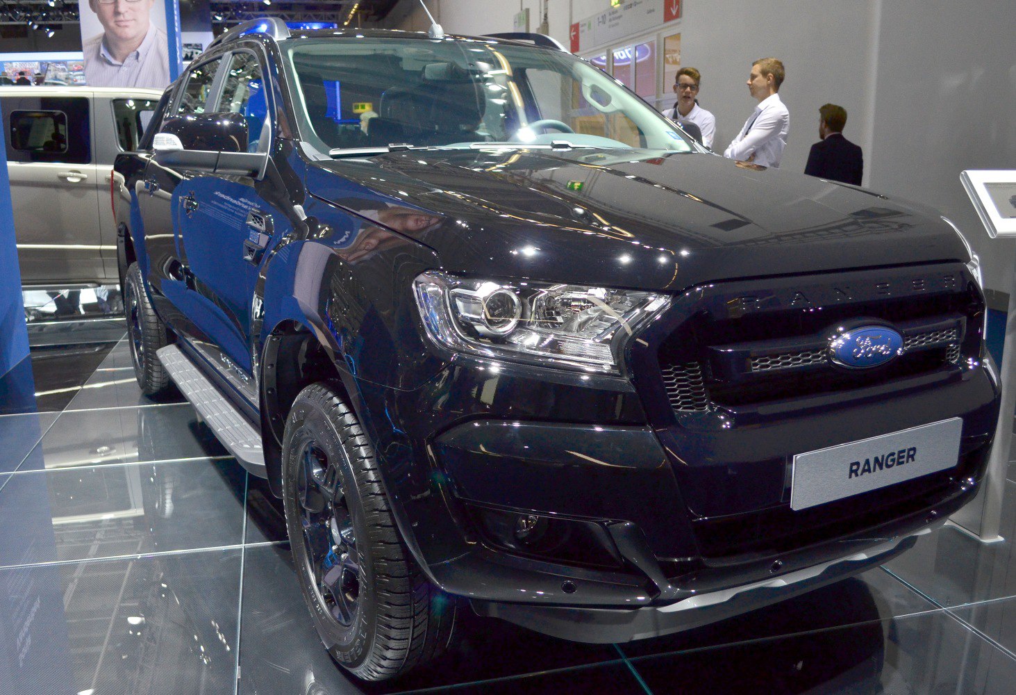Front-side view of black pickup truck with LED headlights and alloy wheels