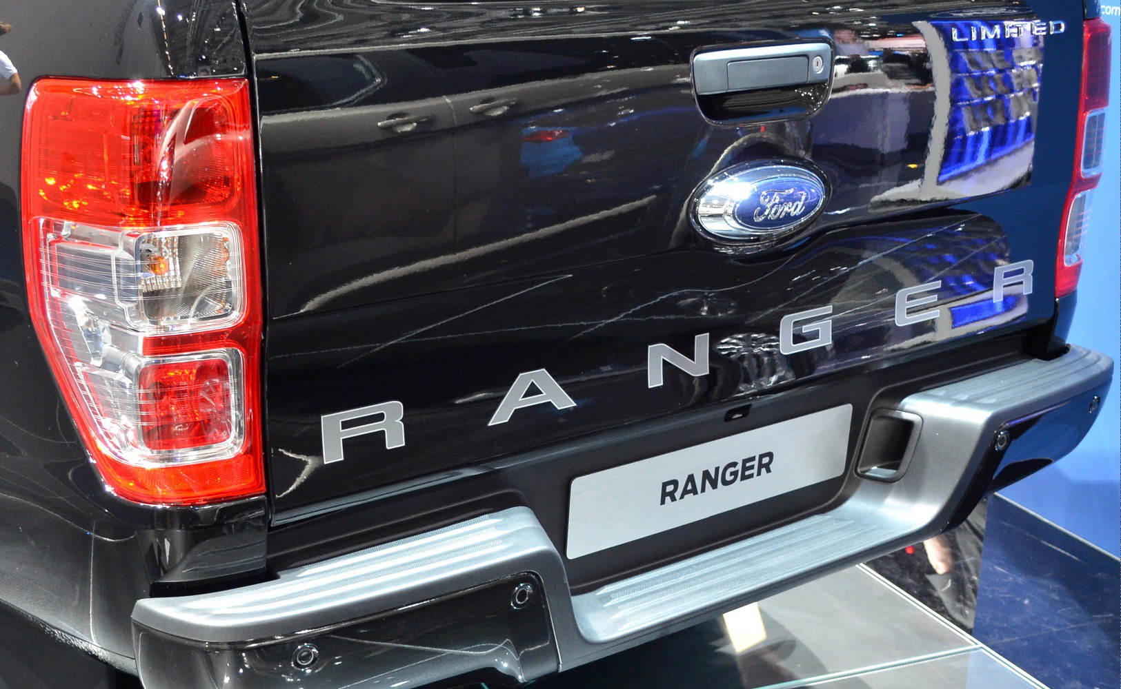 Tailgate, rear light, and bumper details of a pickup truck