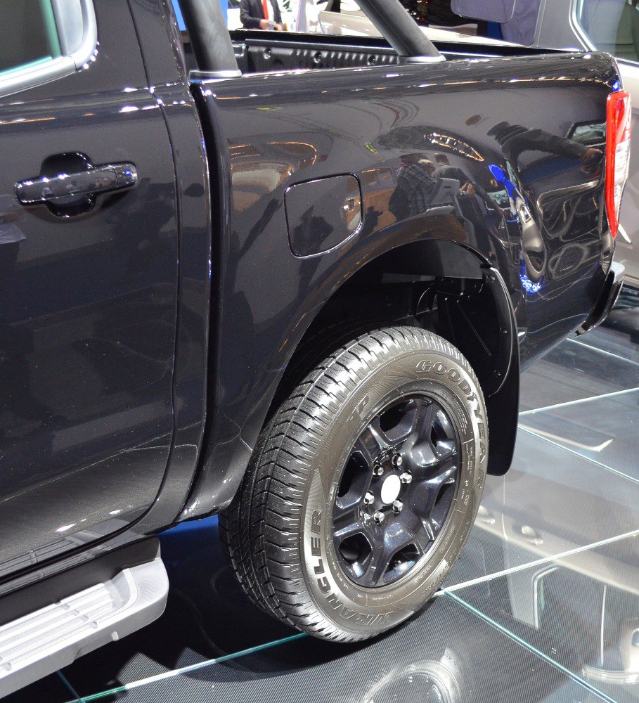 Black pickup truck rear side with alloy wheels and fuel door