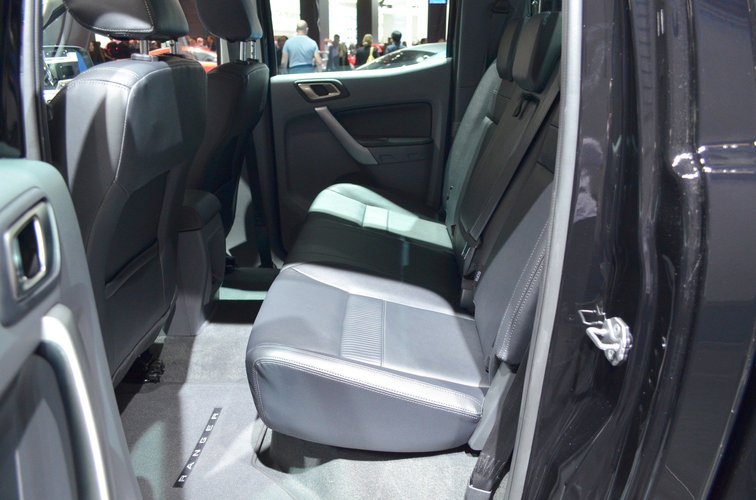 Spacious rear seating area with leather upholstery and seatbelts