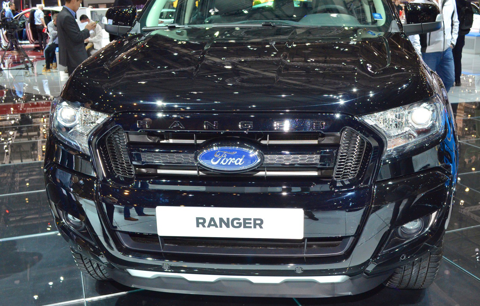 Close-up of front grille, headlights, and bumper of a pickup truck