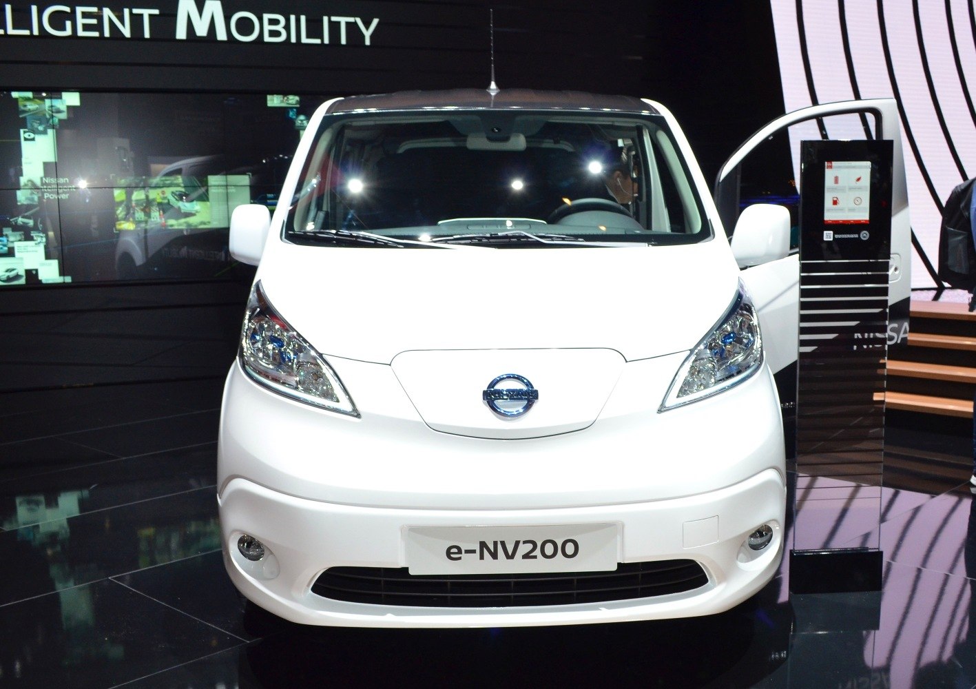 Front view of electric van with headlights and emblem
