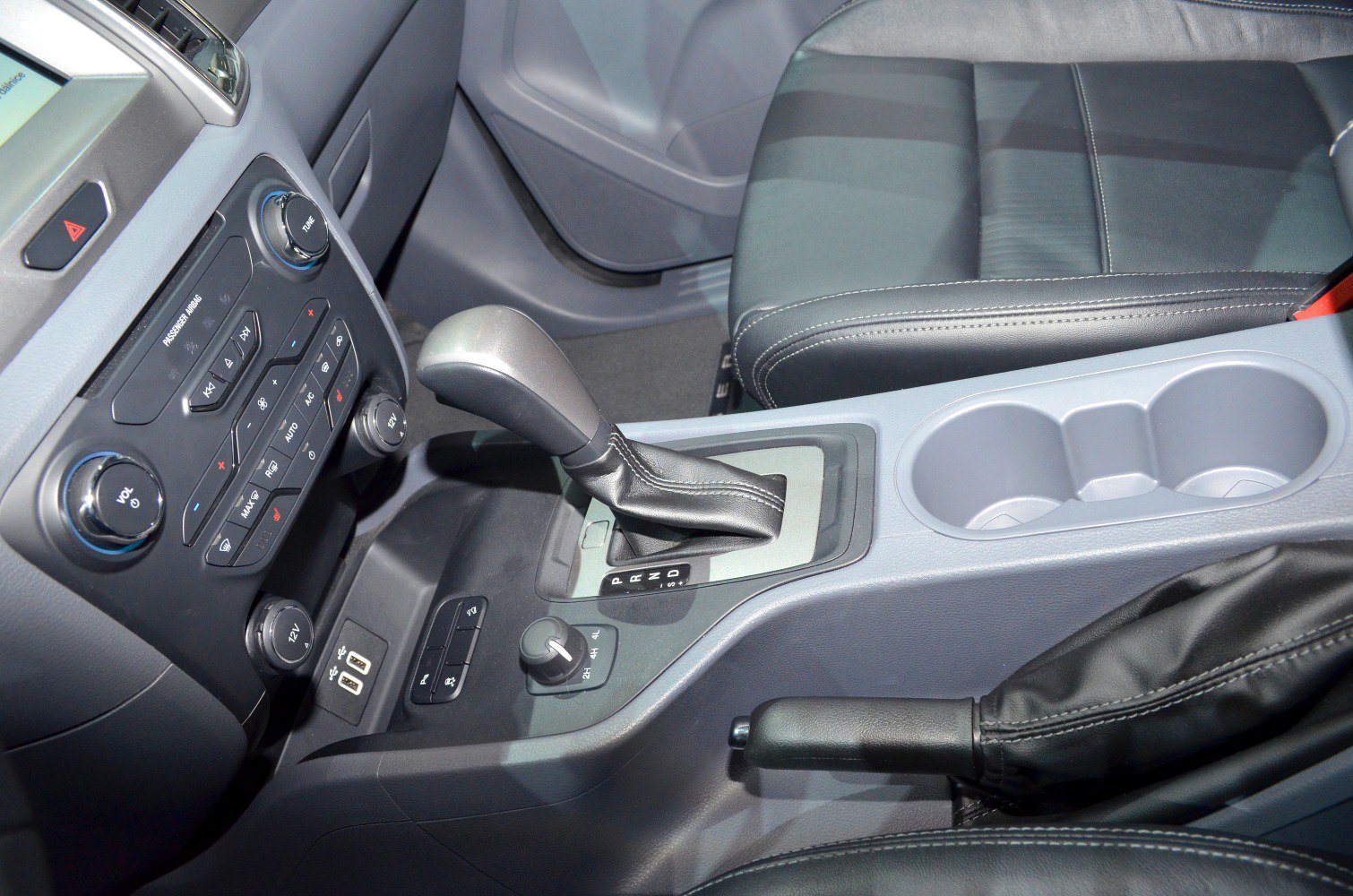 Interior console with gear shift, cup holders, dashboard controls