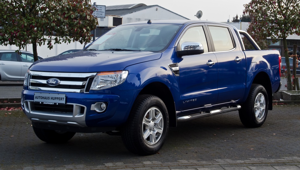 Blue double cab pickup with chrome grille and side steps