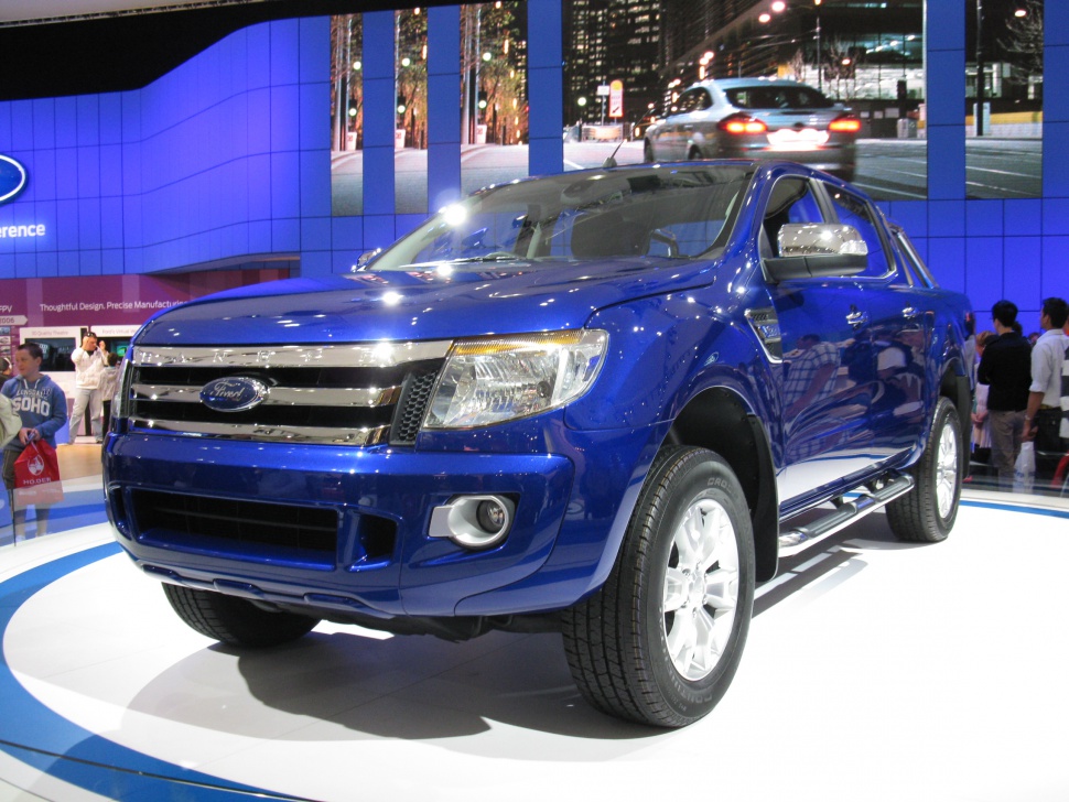 Blue double cab pickup with chrome grille and fog lights
