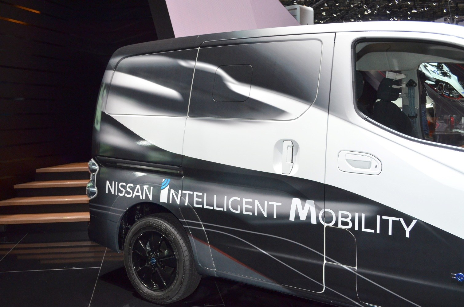 Rear and side view of Nissan e-NV200 with Intelligent Mobility decal and black wheel