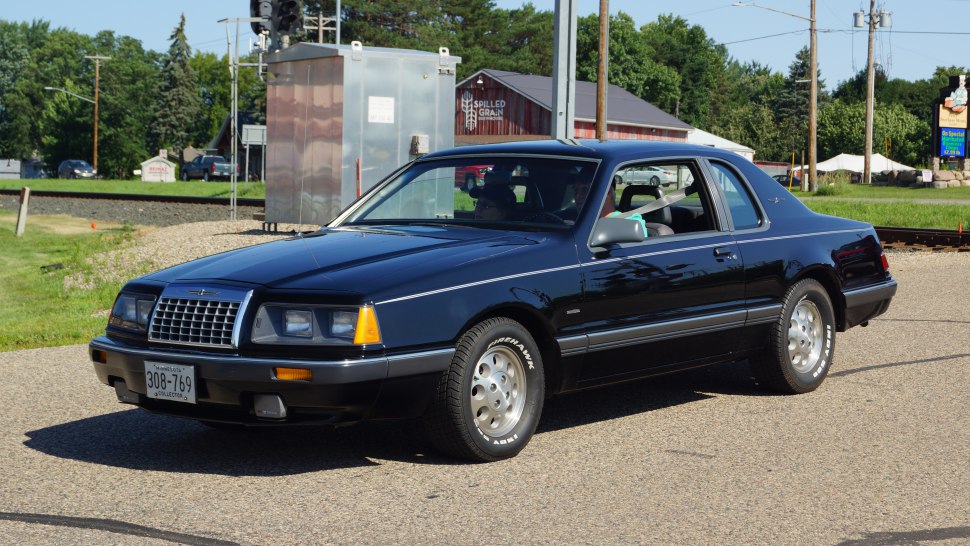 Front side view of a sleek two-door coupe with signature headlights