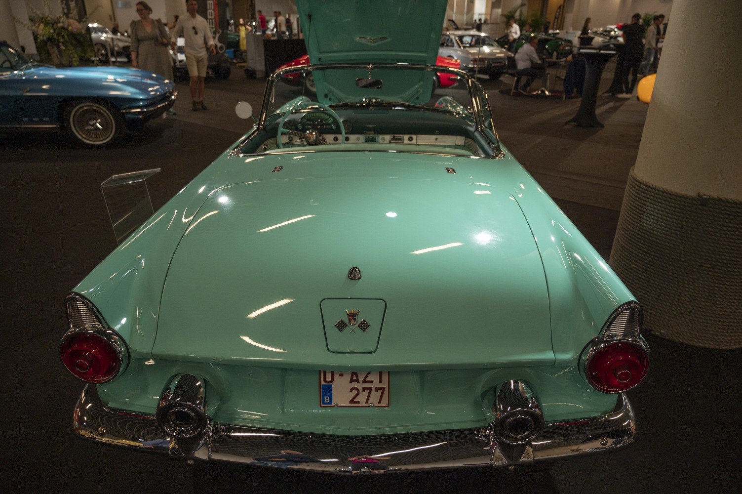 Rear view of convertible with round tail lights and visible open interior.