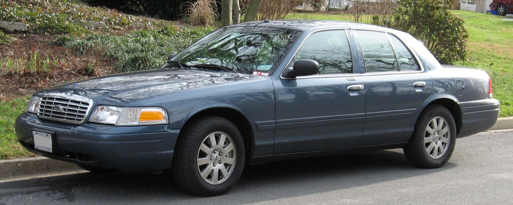 Side and front view of a sedan with classic grille and alloy wheels