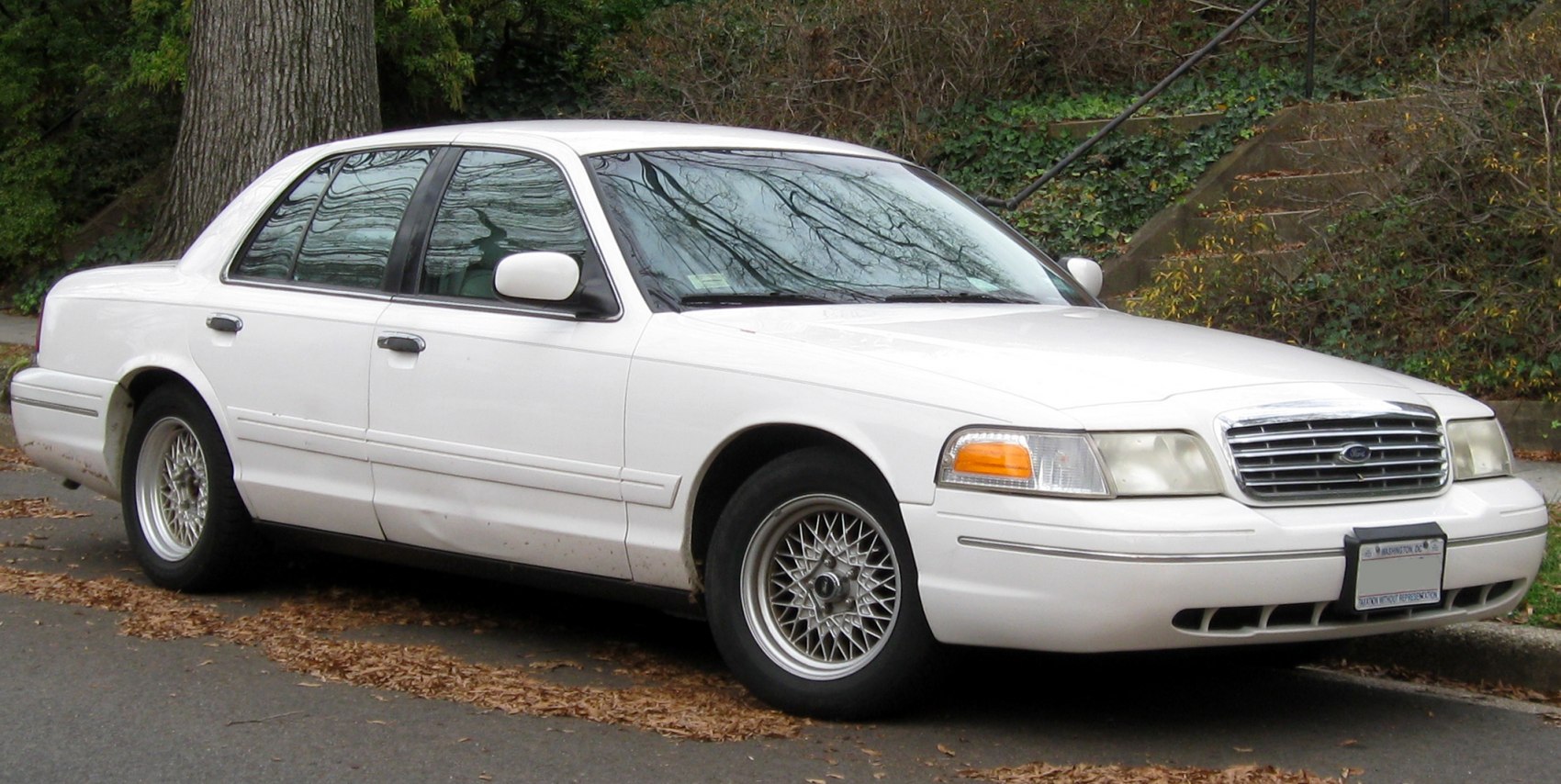 Front and side view of a sedan with mesh style wheels and distinctive grille