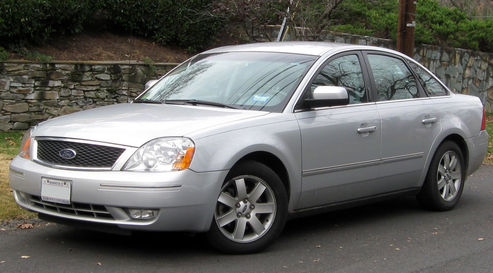 Silver sedan front side with distinctive grille and alloy wheels