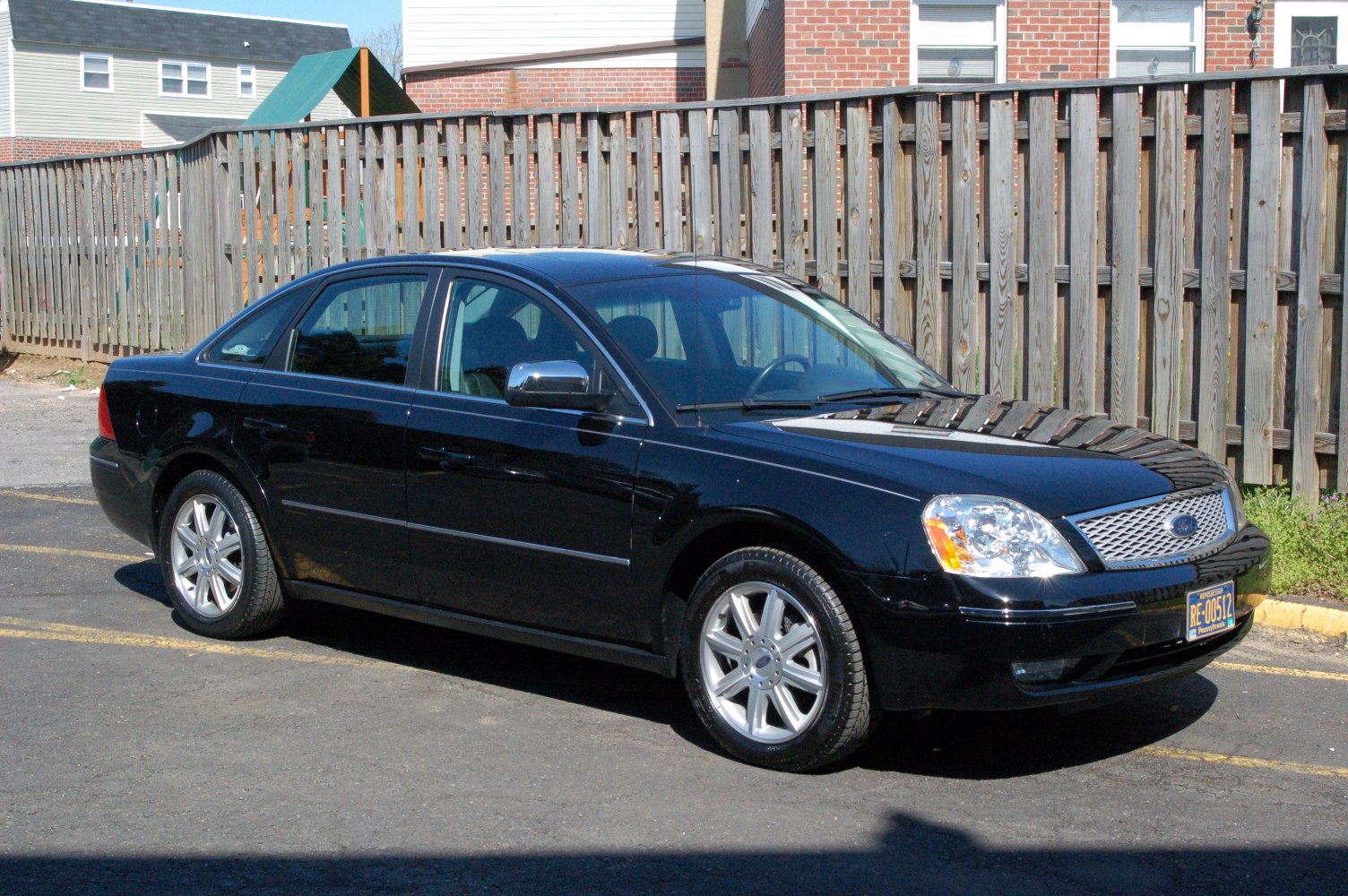 Black sedan with chrome grille and alloy wheels