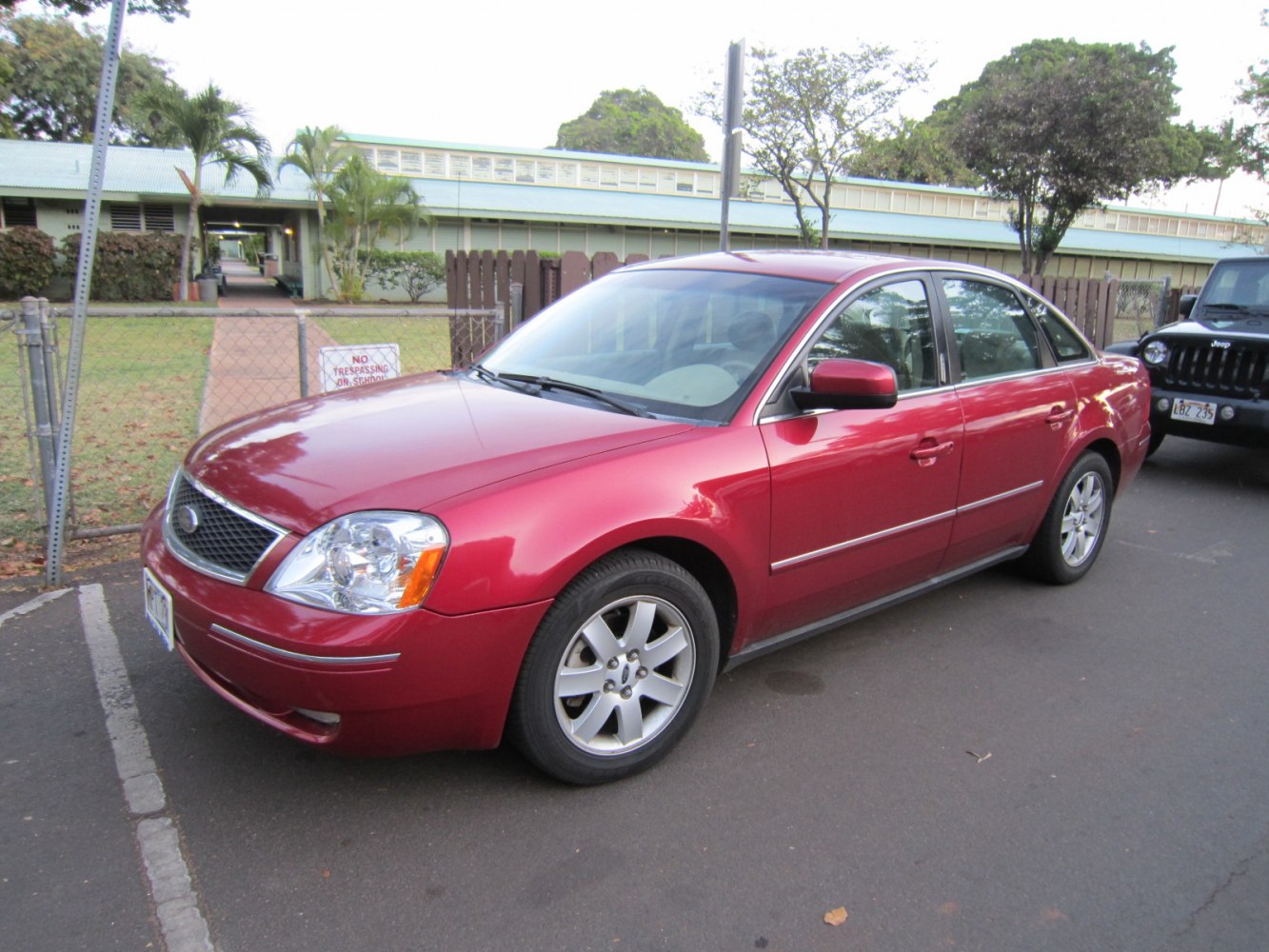 Red sedan with alloy wheels and front side view angle
