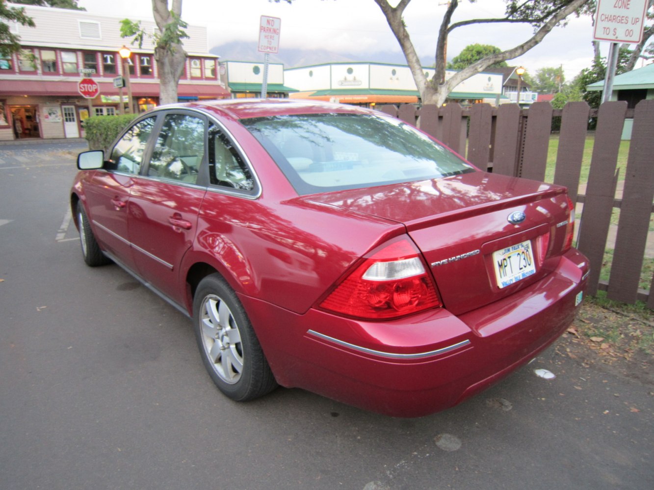 Rear side view of a classic sedan with signature taillights and alloy wheels