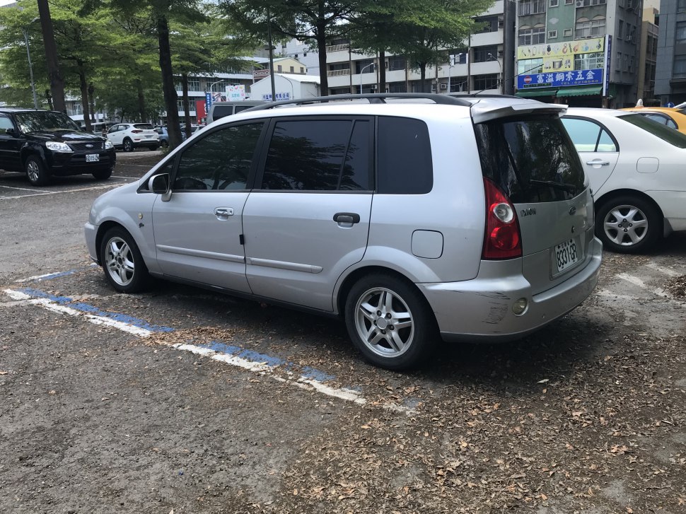 Silver MPV rear side view with alloy wheels and tinted windows