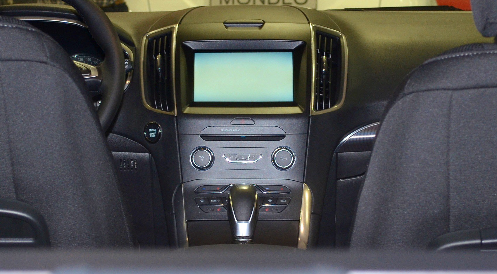 Dashboard with touchscreen and gear shifter between front seats